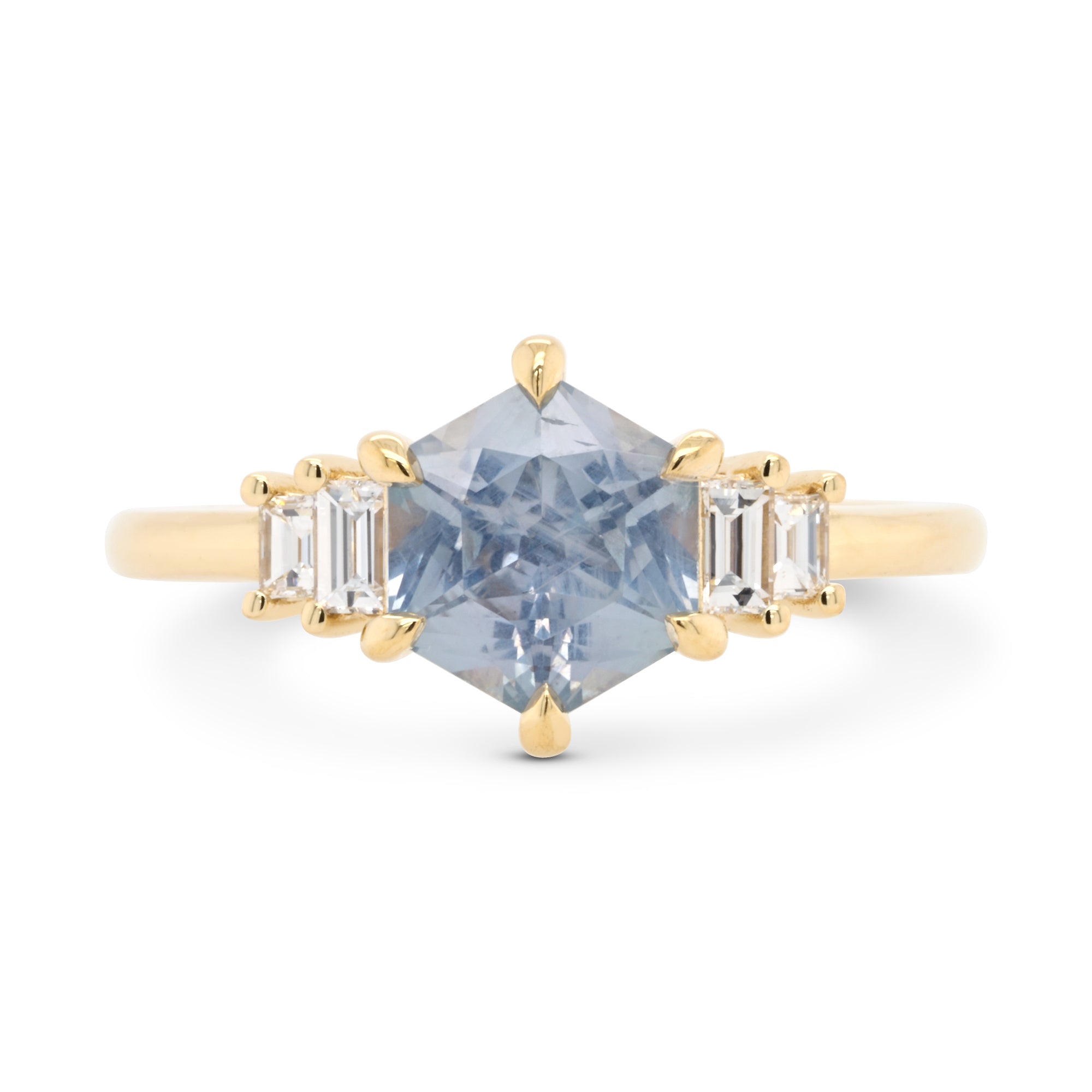 Light blue Montana hexagon sapphire engagement ring with baguette diamonds set in 14k yellow gold