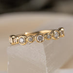 Diamond and 14k yellow gold bezel set wedding band