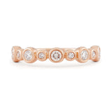 Diamond and 14k rose gold bezel set wedding band