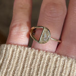 Video of a Half moon diamond in a split shank 14k yellow gold engagement ring setting on a hand