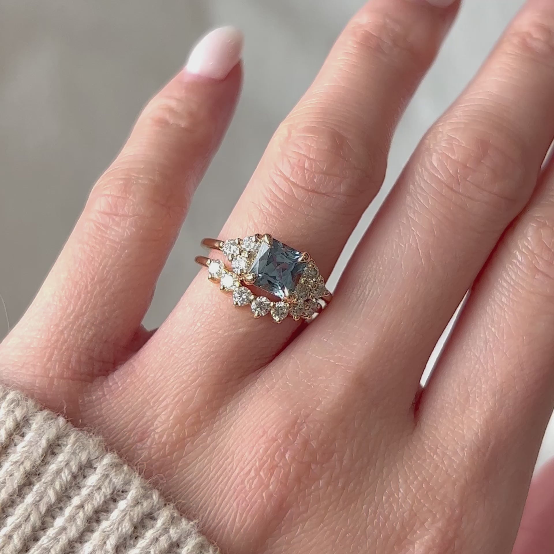 Video of Vintage 14k yellow gold light blue sapphire engagement ring worn with curved diamond wedding band