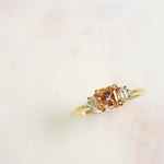 14k yellow gold peach Asscher cut sapphire with round and baguette diamond side stones engagement ring