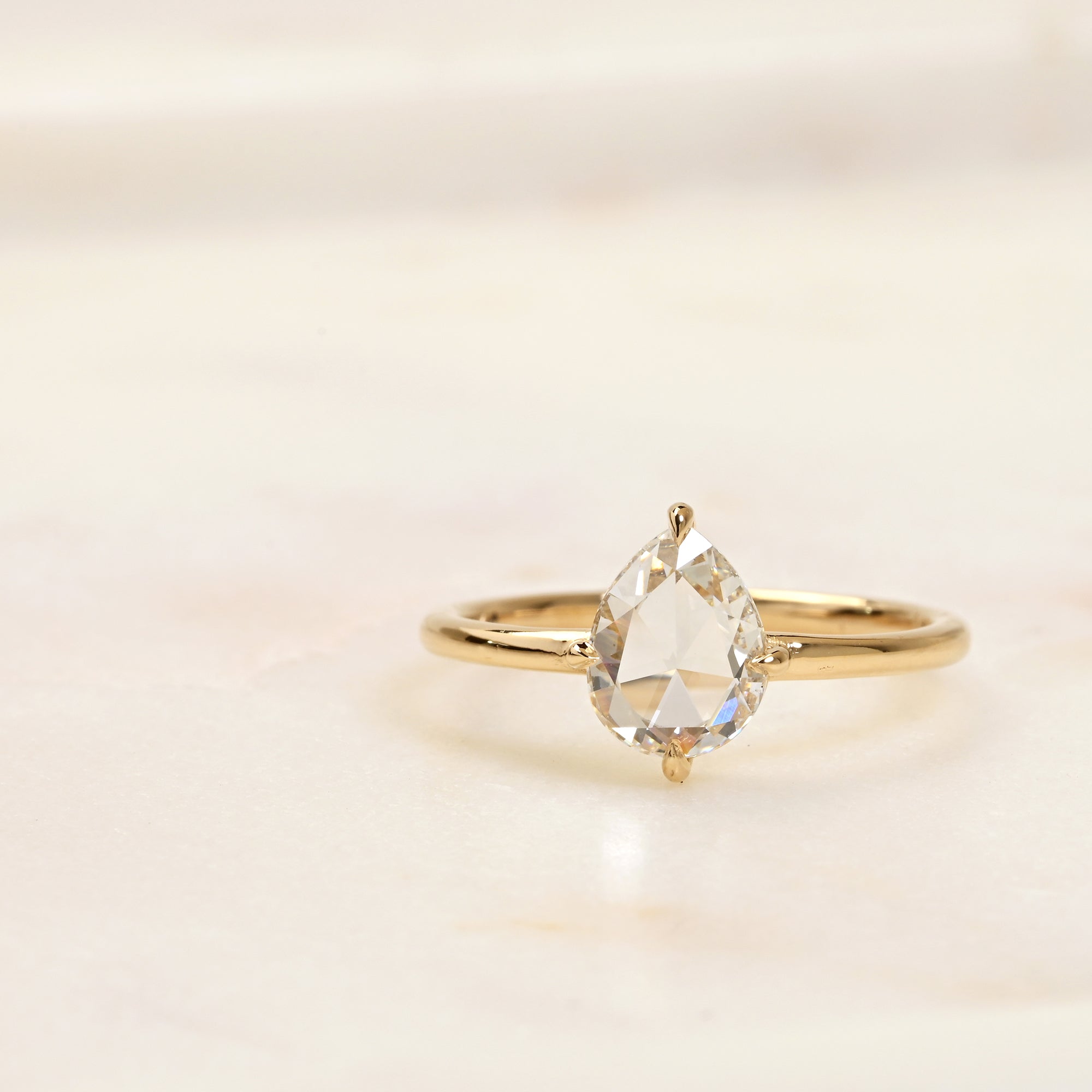 Rose cut pear diamond in a 14k yellow gold solitaire engagement ring setting
