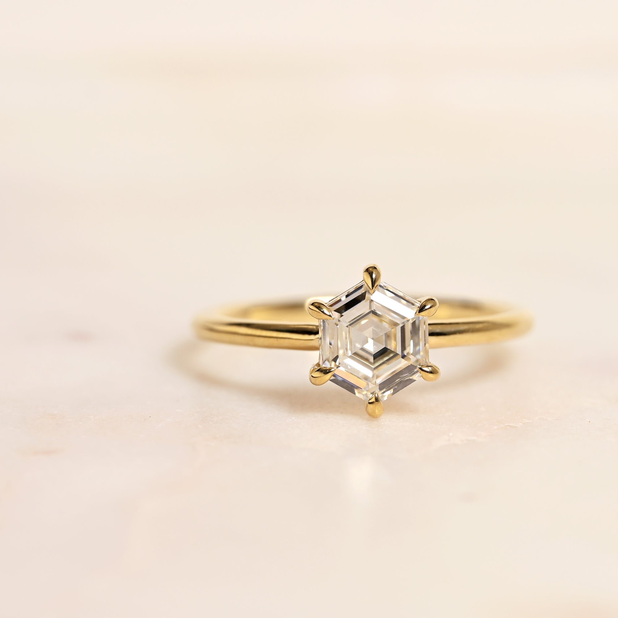 Modern natural hexagon colorless diamond in 14k yellow gold solitaire setting with six prong