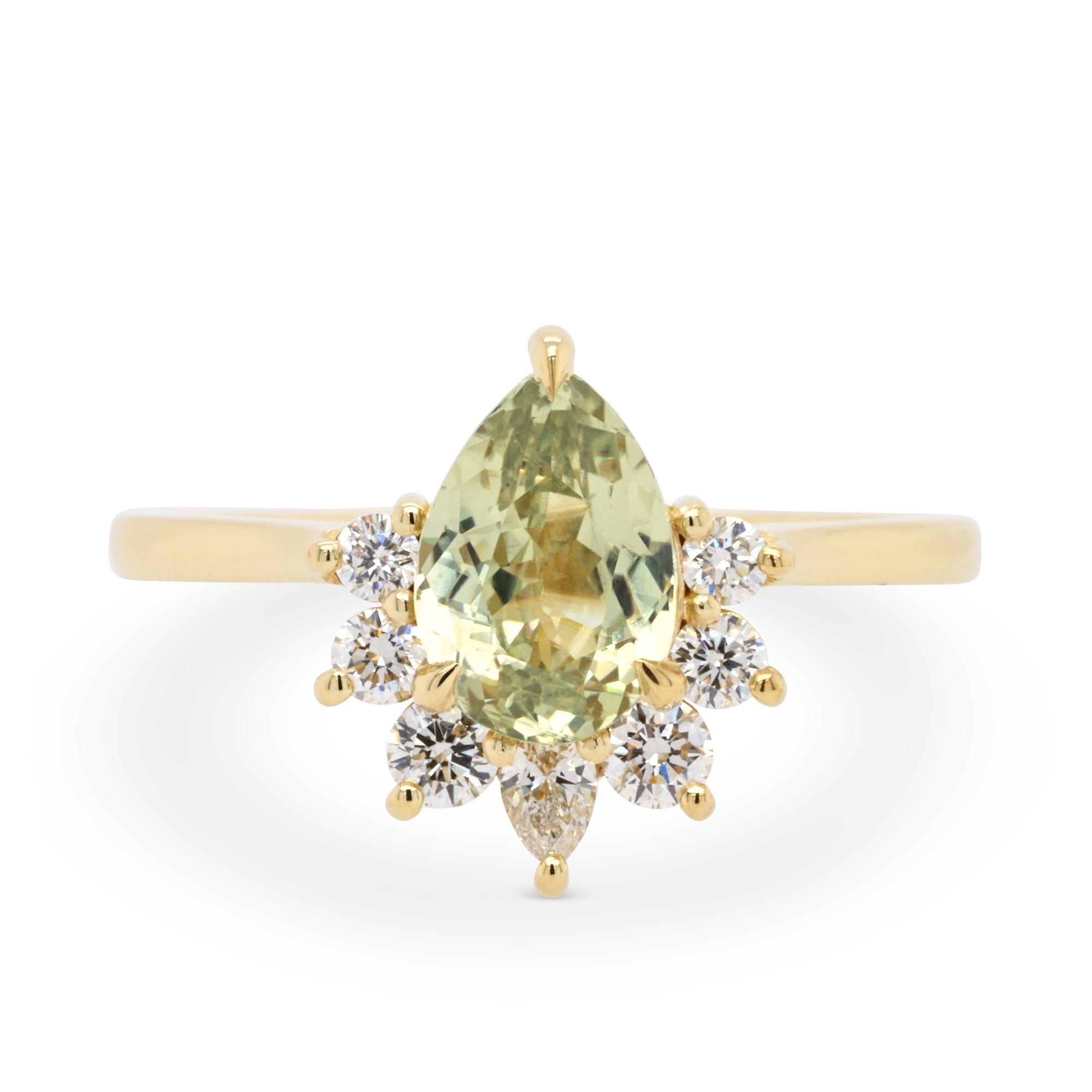 Light green pear shaped sapphire engagement ring with a 14k yellow gold diamond half halo setting