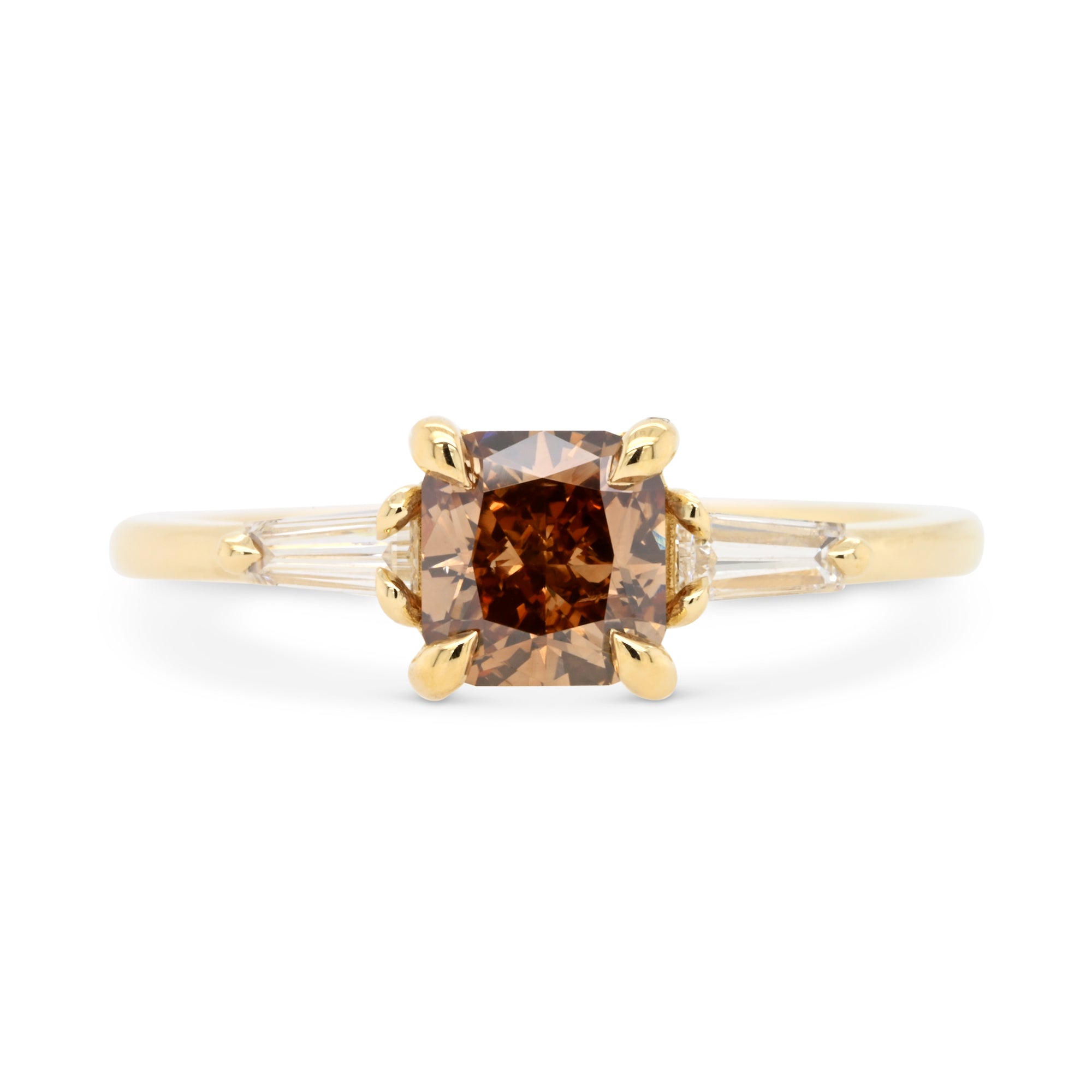 14k yellow gold engagement ring with a fancy brown cushion diamond and tapered baguette diamond accents