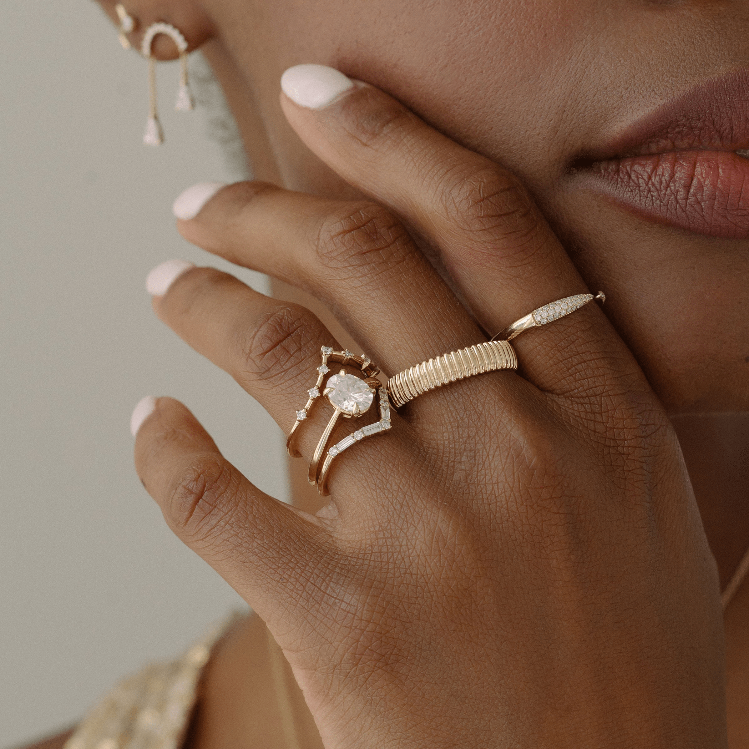 Five 14k yellow gold rings modeled on a hand 
