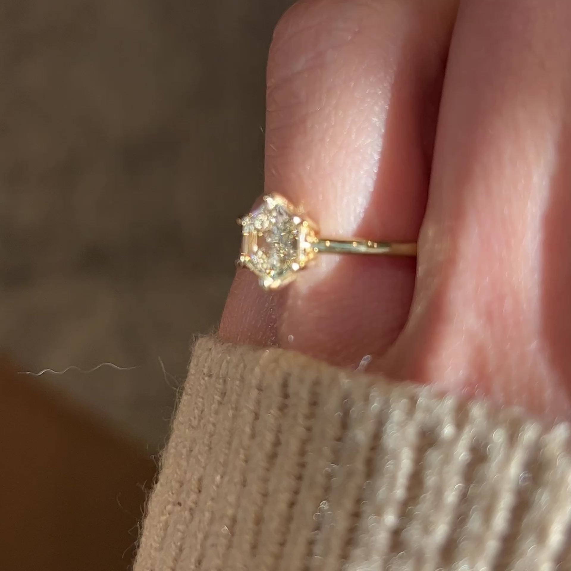 Video of hexagon diamond engagement ring in 14k yellow gold solitaire setting with six prongs on a hand