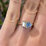 Video of Toi-et-moi baguette diamond and light blue Montana sapphire engagement ring set in 14k yellow gold on a hand