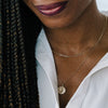 model wearing layered pendant and bar link necklace
