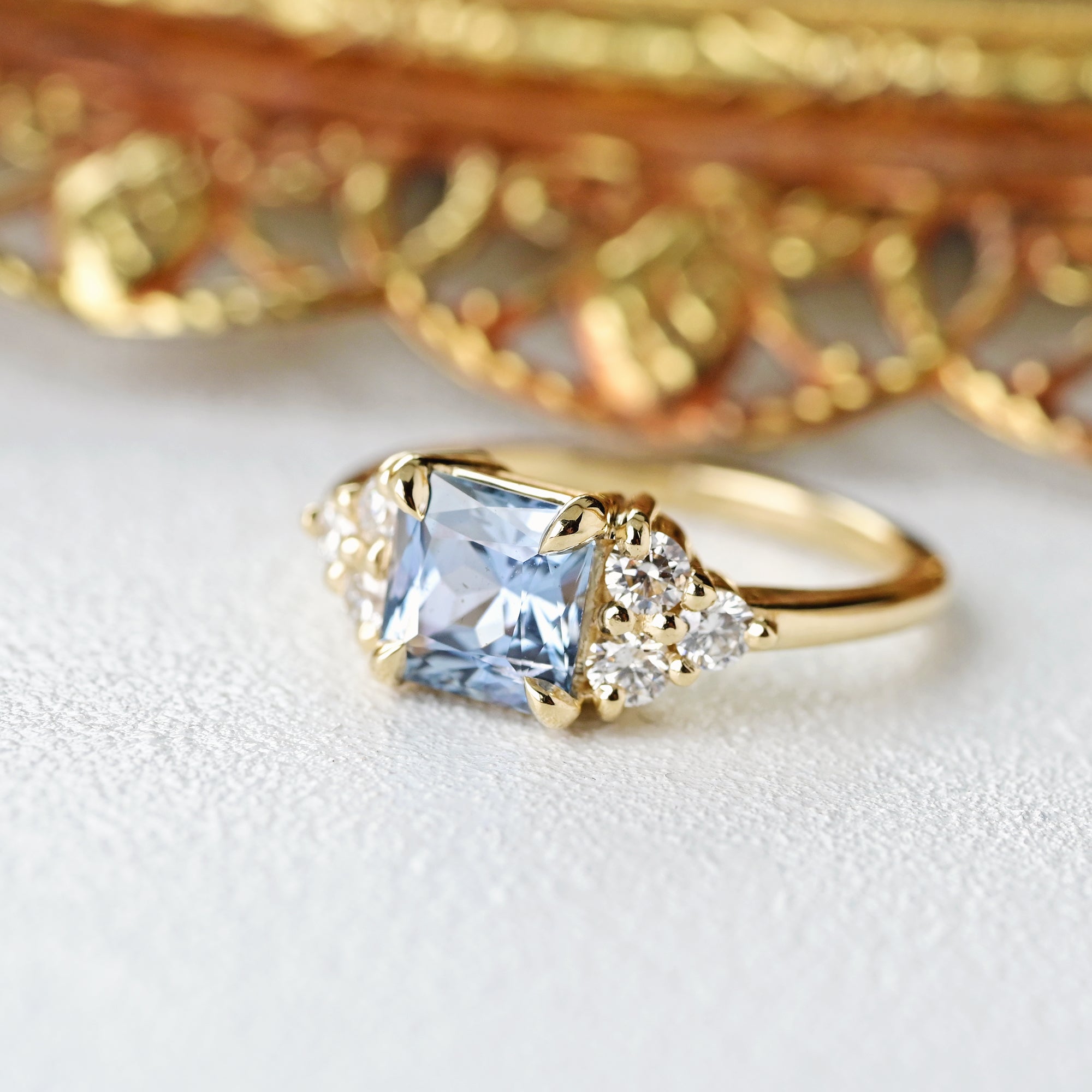 light blue geometric ring with cluster diamonds