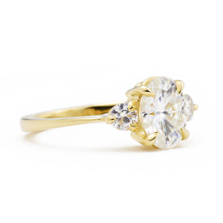 Zara Oval Three Stone Moissanite Engagement Ring in yellow gold